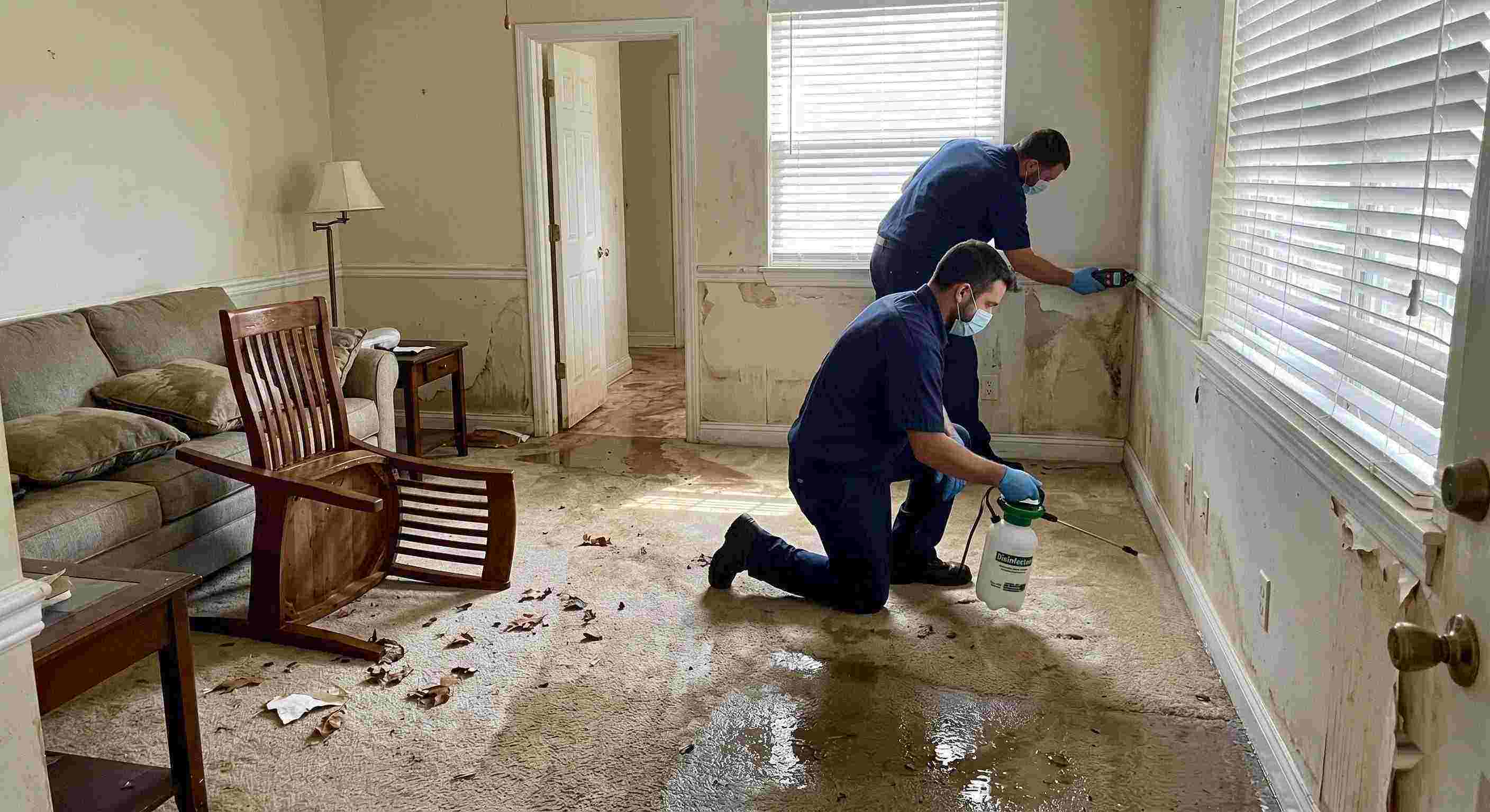 Technicians performing flood disinfection after water damage inside a home in Cape Coral, ensuring wet floors, damp walls, and household items are sanitized safely.